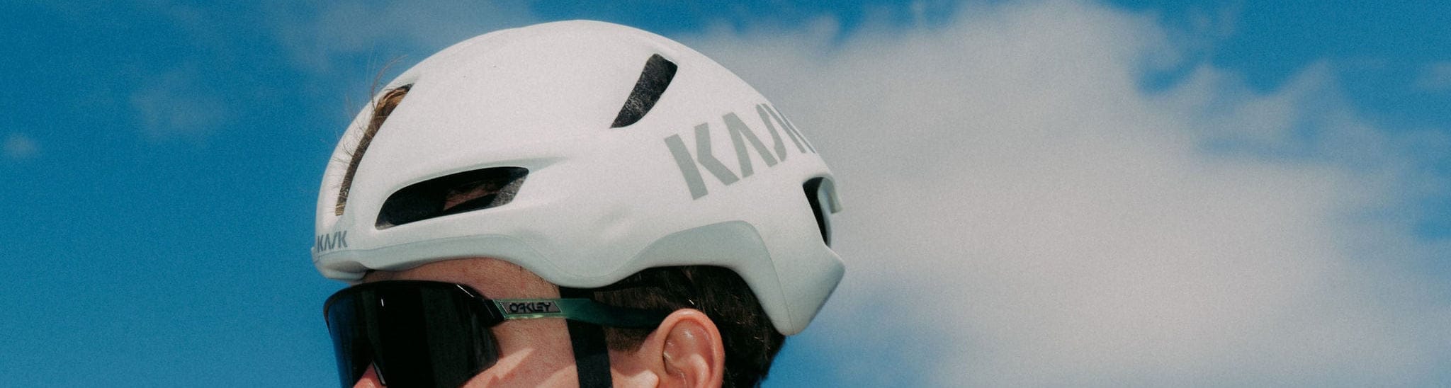Cyclist in Rapha clothing sitting on a bike with a clear blue sky in the background
