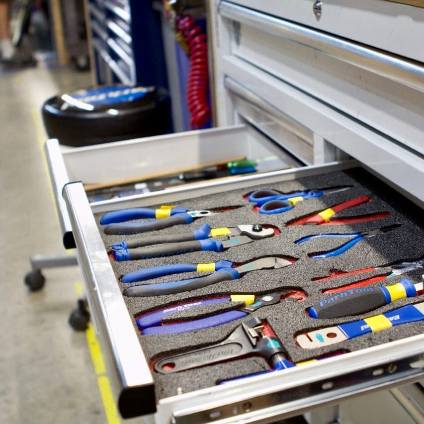 Open tool drawer with various tools inside, featuring a Husky toolbox.